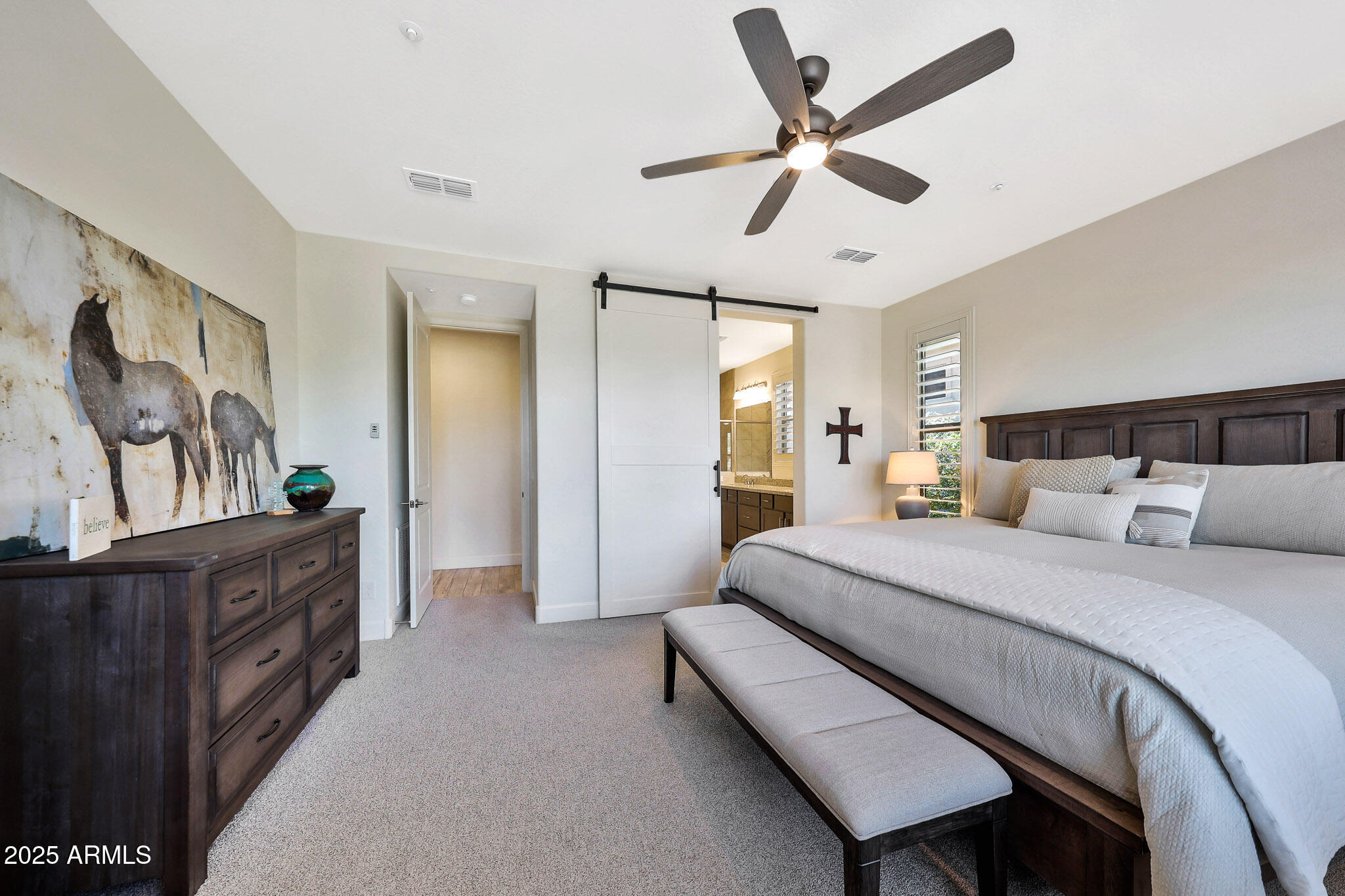 17940 East Cindercone Road Rio Verde, AZ 85263 - Photo 15 of 42 a bedroom with a bed and a chandelier