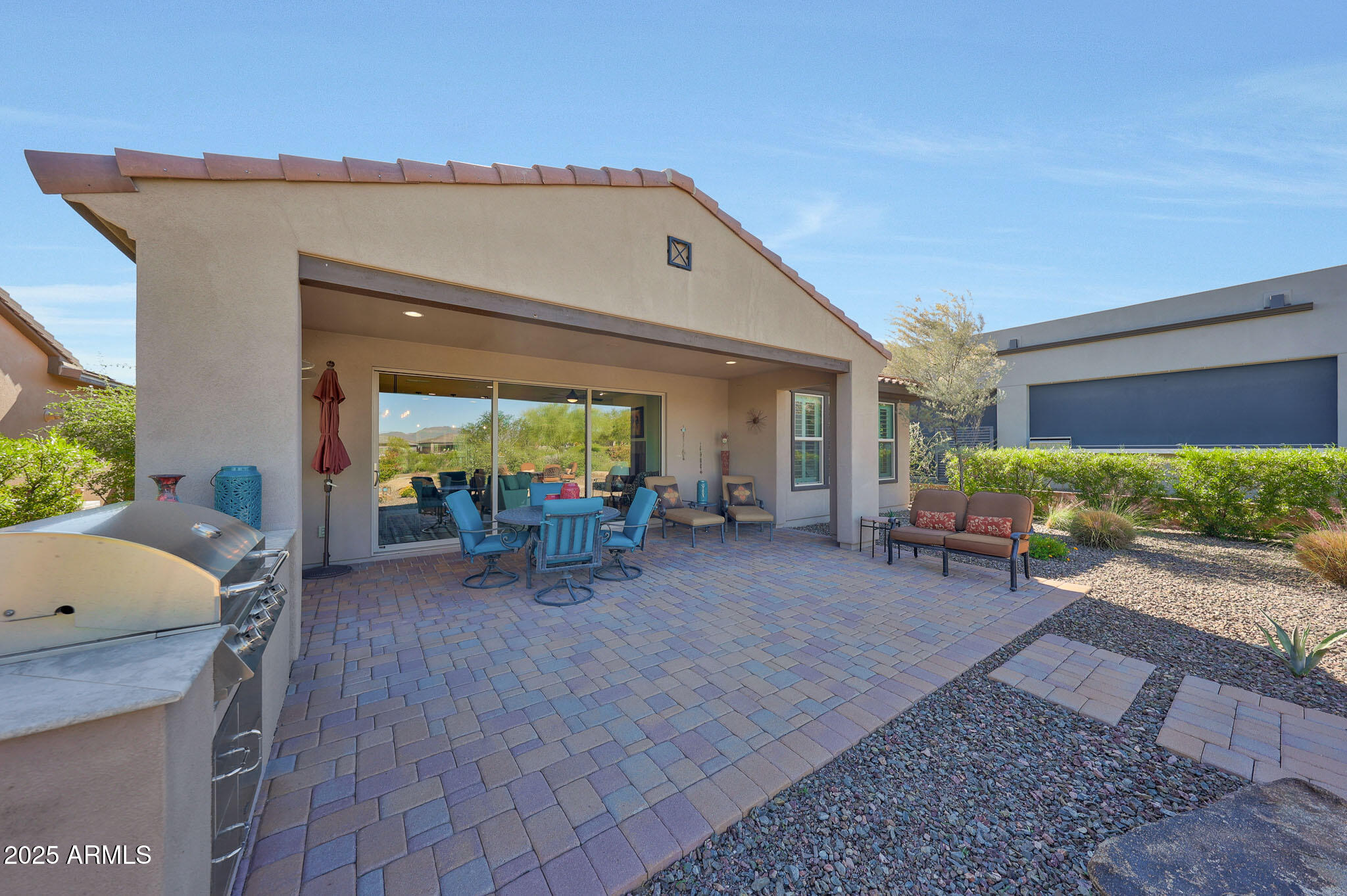 17940 East Cindercone Road Rio Verde, AZ 85263 - Photo 26 of 42 a view of a patio with table and chairs next to a yard