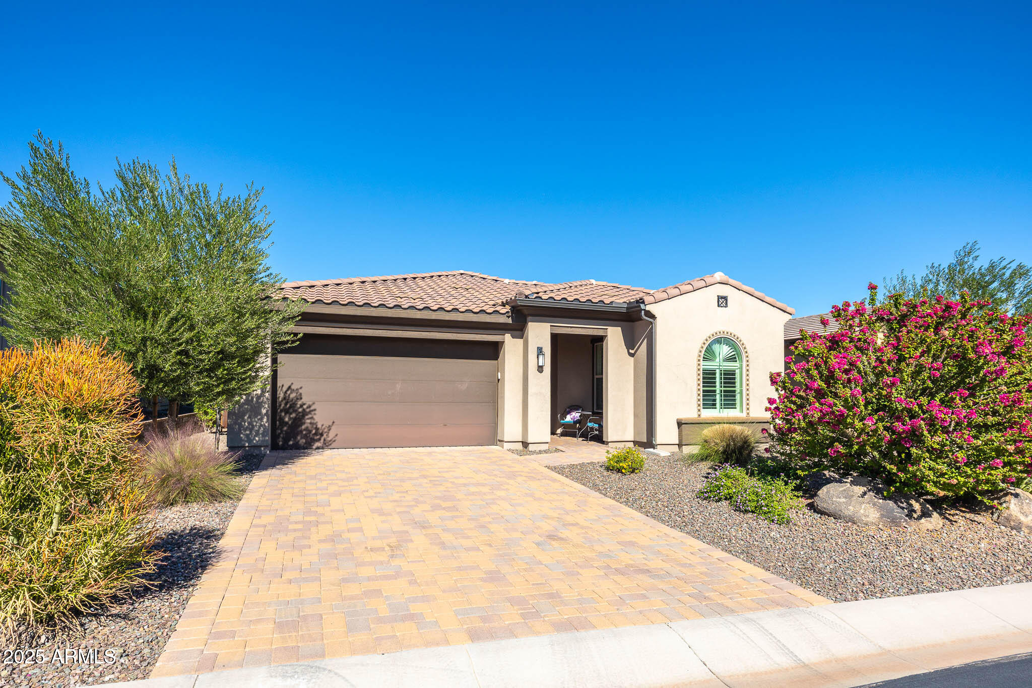 17940 East Cindercone Road Rio Verde, AZ 85263 - Photo 40 of 42 a view of a white house with a yard and potted plants