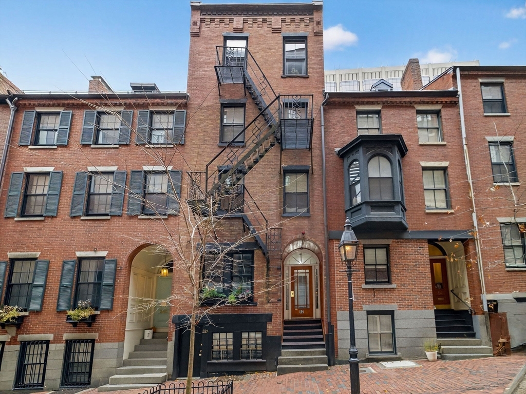 a front view of a residential apartment building with a yard