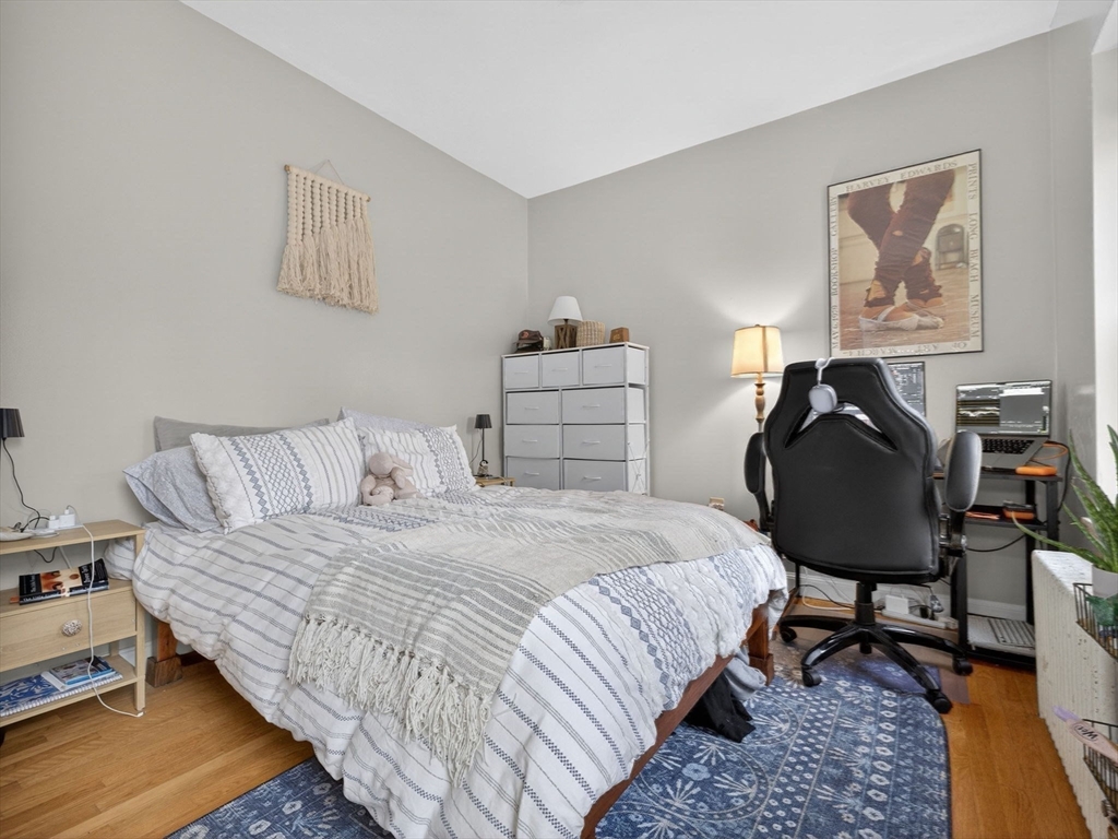 52 Temple Street Boston, MA 02114 - Photo 14 of 34 a bedroom with a bed and chair