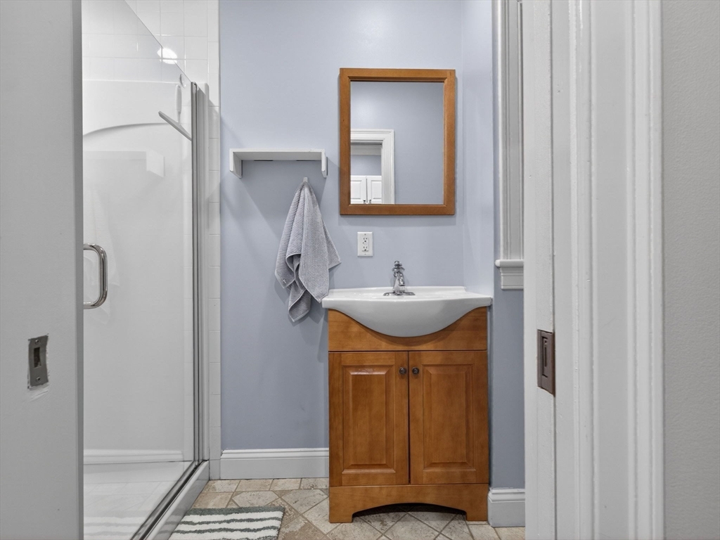 52 Temple Street Boston, MA 02114 - Photo 15 of 34 a bathroom with a sink and a mirror