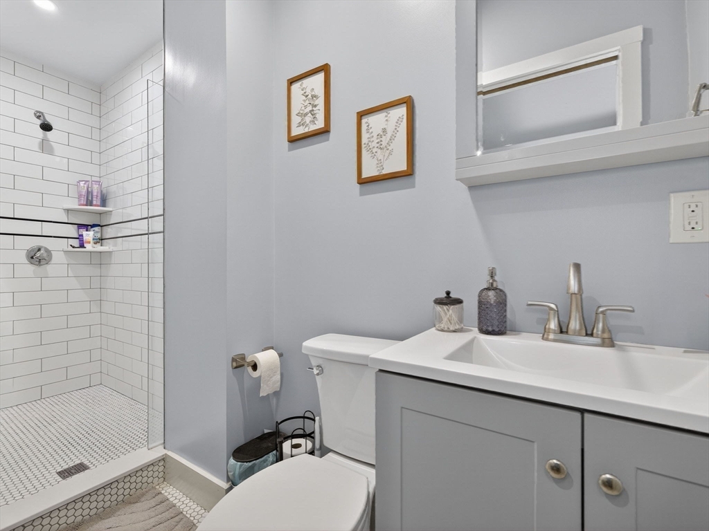 52 Temple Street Boston, MA 02114 - Photo 19 of 34 a bathroom with a sink toilet and shower