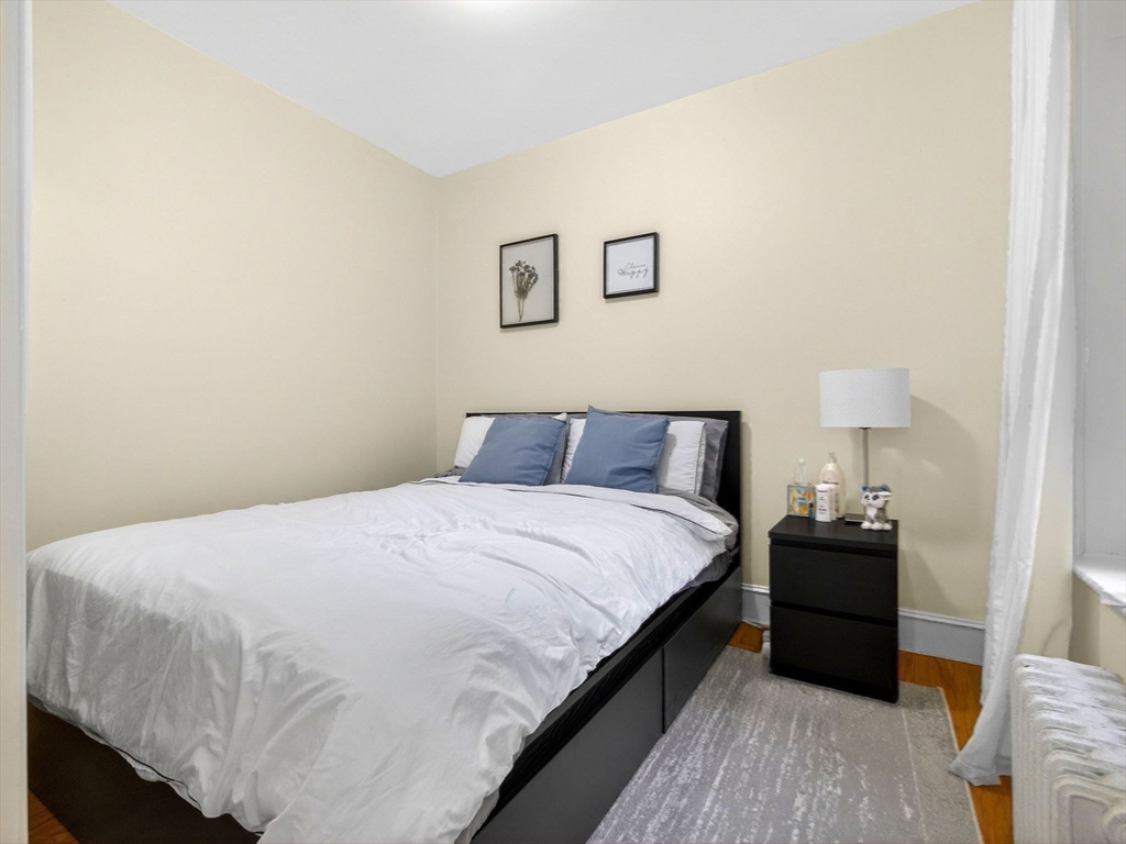 52 Temple Street Boston, MA 02114 - Photo 20 of 34 a bedroom with a bed and a night stand
