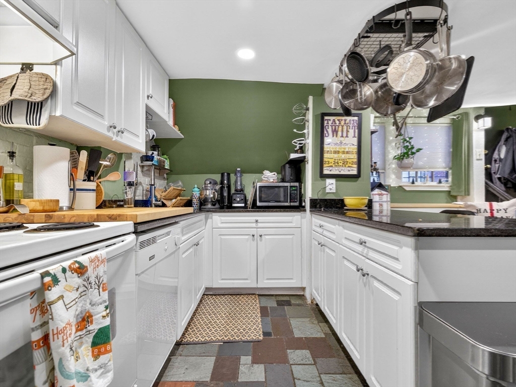 52 Temple Street Boston, MA 02114 - Photo 22 of 34 a kitchen with a sink cabinets and window