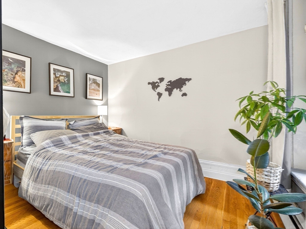 52 Temple Street Boston, MA 02114 - Photo 26 of 34 a bedroom with bed and a potted plant