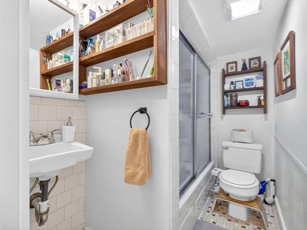 52 Temple Street Boston, MA 02114 - Photo 29 of 34 a bathroom with a sink toilet and shower