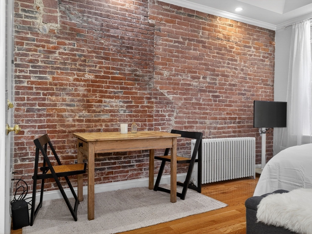 52 Temple Street Boston, MA 02114 - Photo 7 of 34 a work room with furniture wooden floor and a lamp