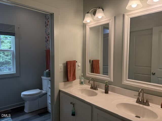 574 East Ridge Avenue Liberty, NC 27298 - Photo 21 of 28 a bathroom with a toilet sink and mirror