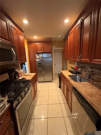 a kitchen with stainless steel appliances granite countertop a stove and a refrigerator