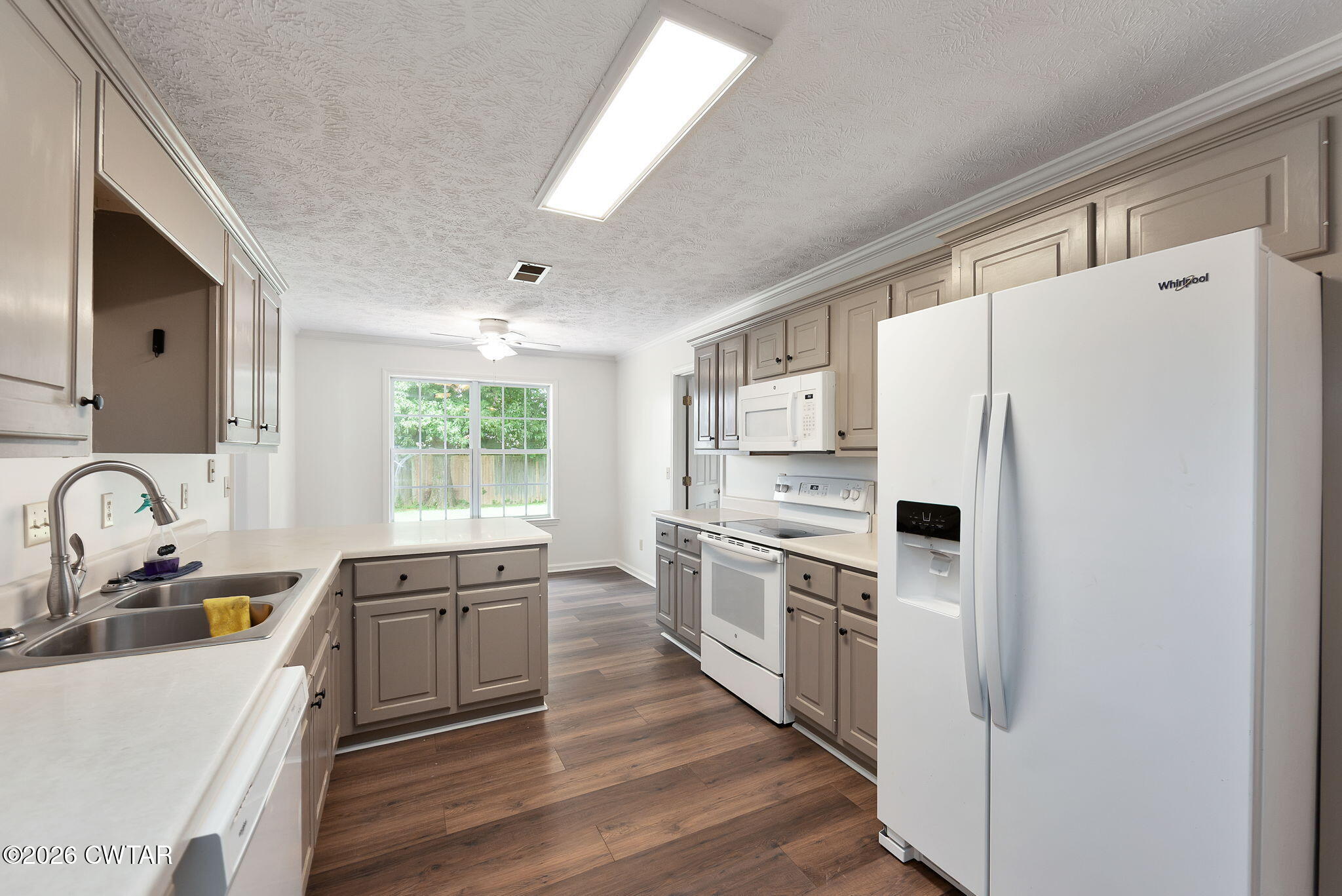 96 Sundown Drive Jackson, TN 38305 - Photo 9 of 28 a kitchen with white cabinets and white appliances