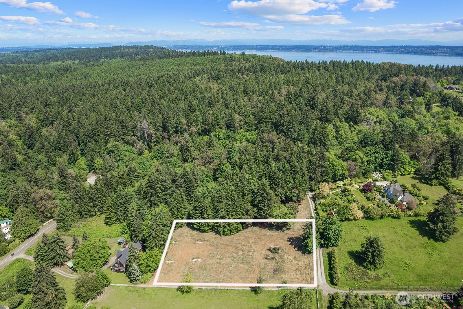 9438 Southwest 266th Lane Vashon, WA 98070 - Photo 10 of 24 an aerial view of residential houses with outdoor space and trees all around