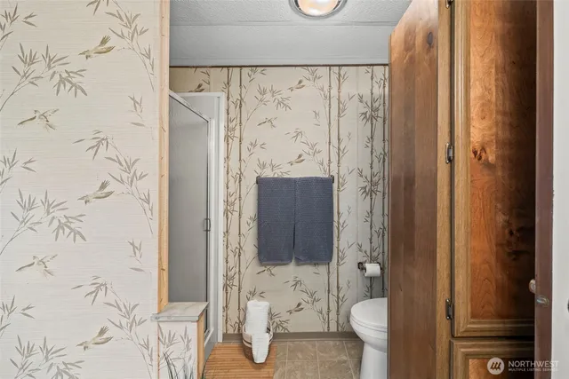 a bathroom with a sink a toilet and shower curtain