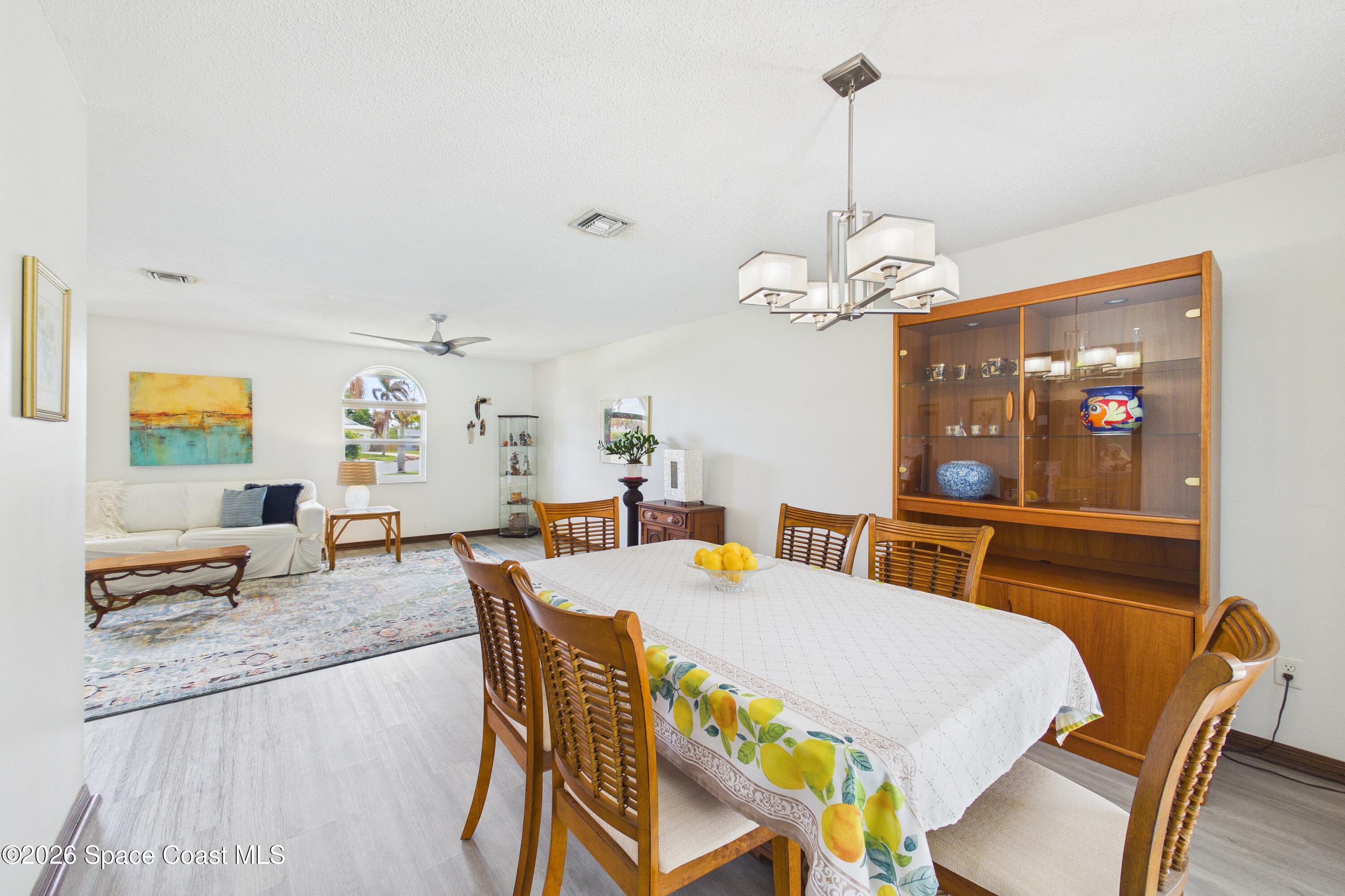 280 Coral Way West Indialantic, FL 32903 - Photo 11 of 72 a view of a dining room with furniture and wooden floor
