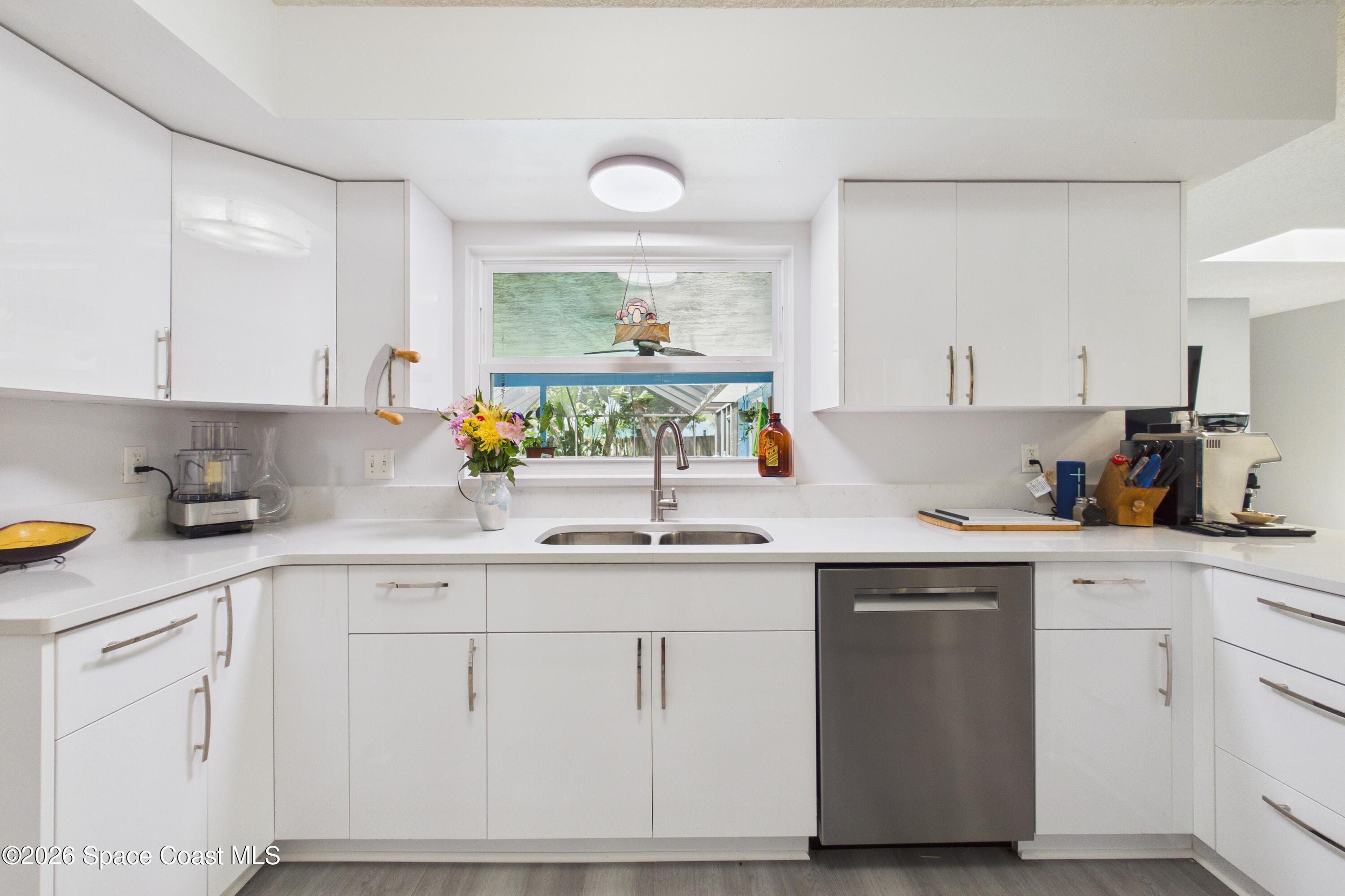 280 Coral Way West Indialantic, FL 32903 - Photo 17 of 72 a kitchen with white cabinets and sink