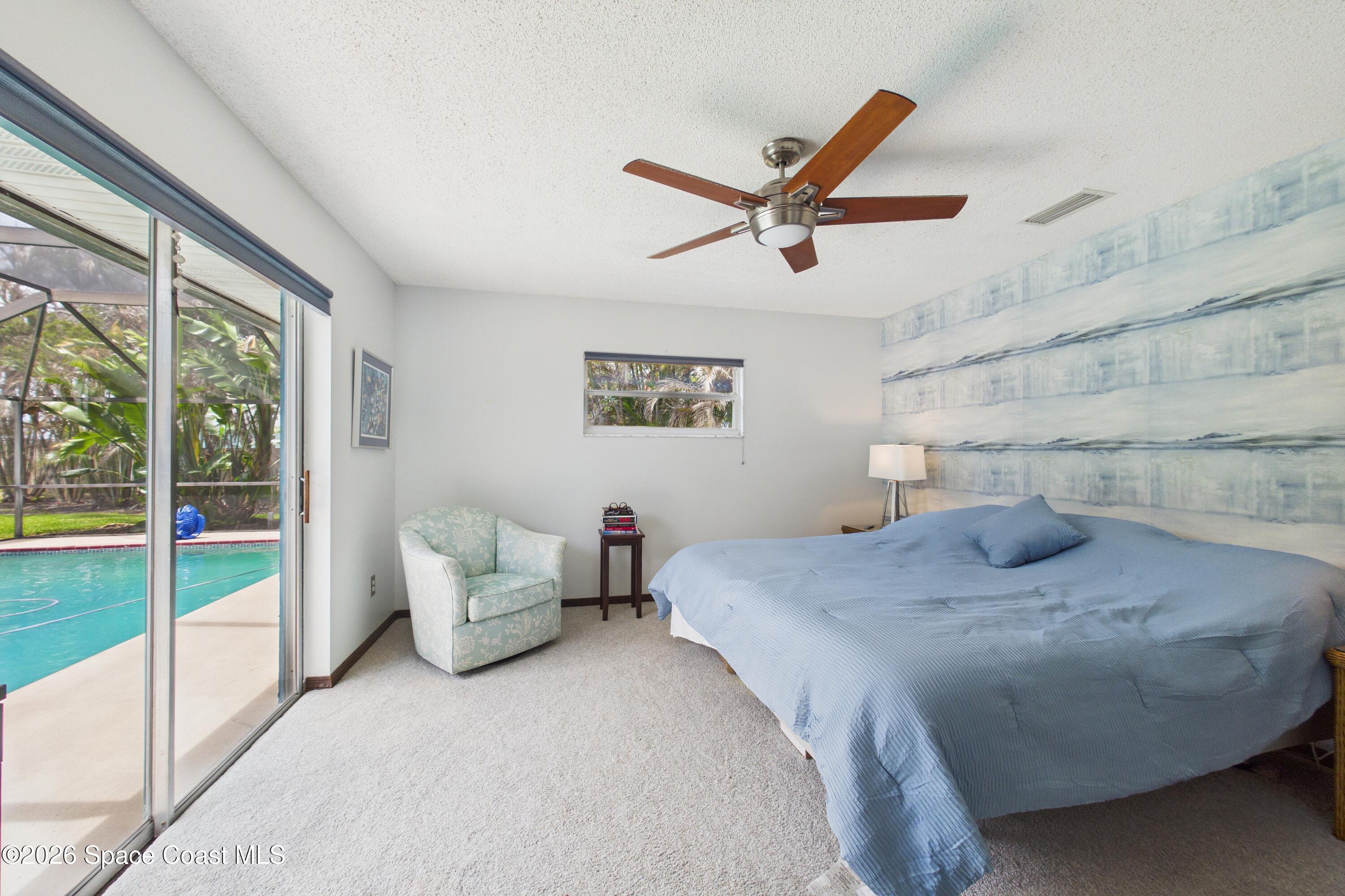 280 Coral Way West Indialantic, FL 32903 - Photo 22 of 72 a bedroom with a bed and ceiling fan