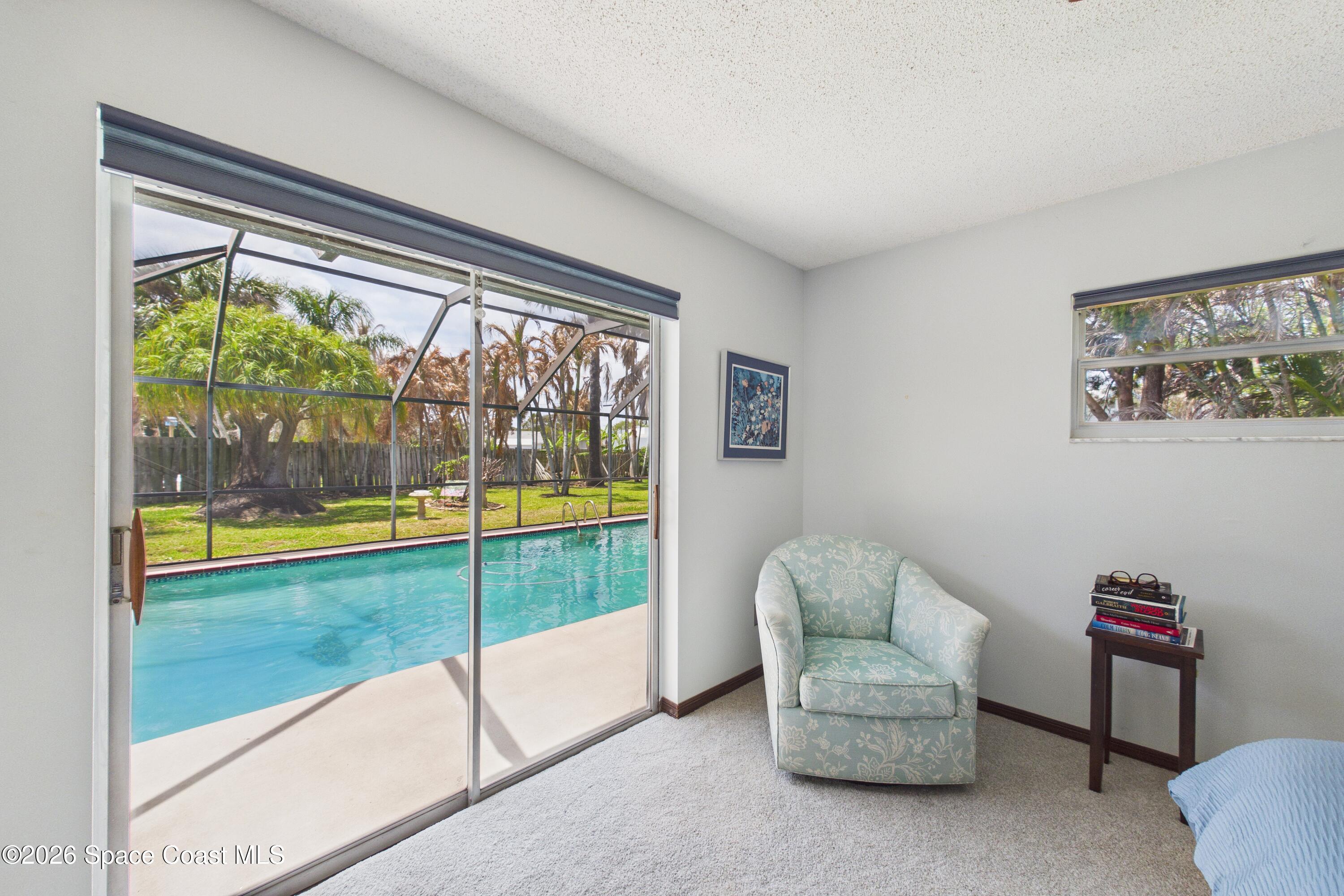 280 Coral Way West Indialantic, FL 32903 - Photo 24 of 72 a living room with a large window and a floor to ceiling window