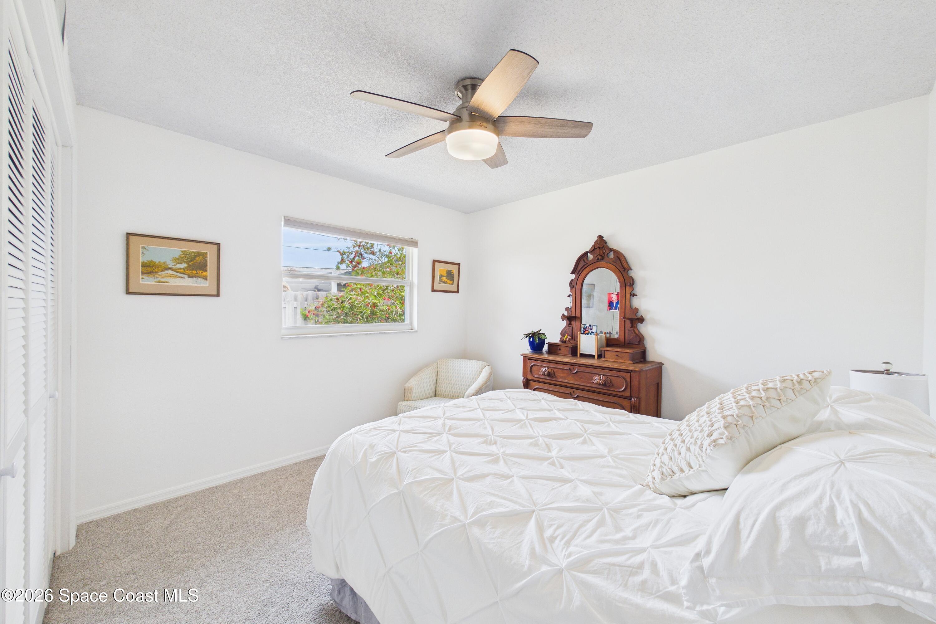 280 Coral Way West Indialantic, FL 32903 - Photo 26 of 72 a bedroom with a bed and a chandelier