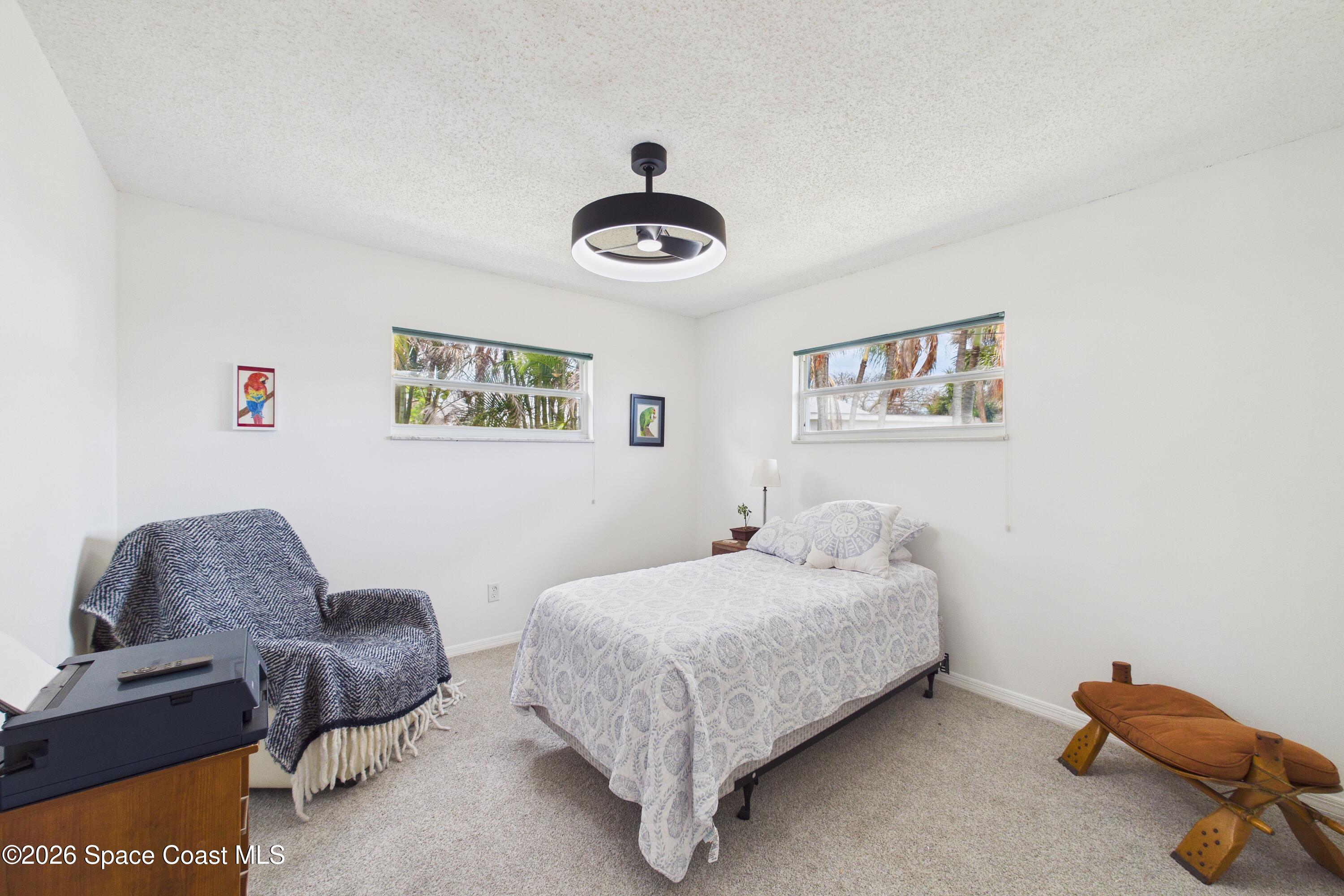 280 Coral Way West Indialantic, FL 32903 - Photo 29 of 72 a bedroom with a bed and a couch