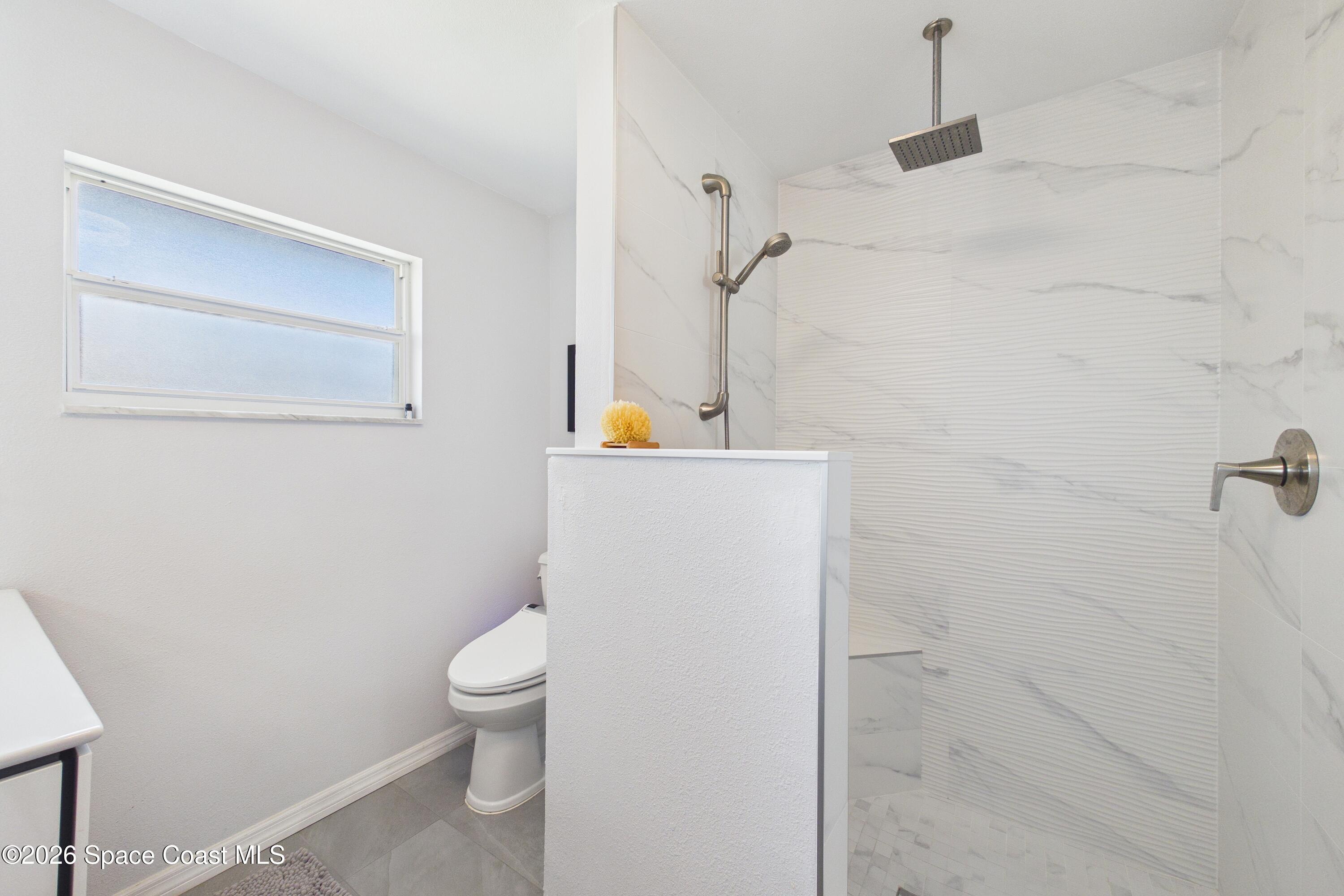 280 Coral Way West Indialantic, FL 32903 - Photo 33 of 72 a white toilet sitting next to a bathroom sink