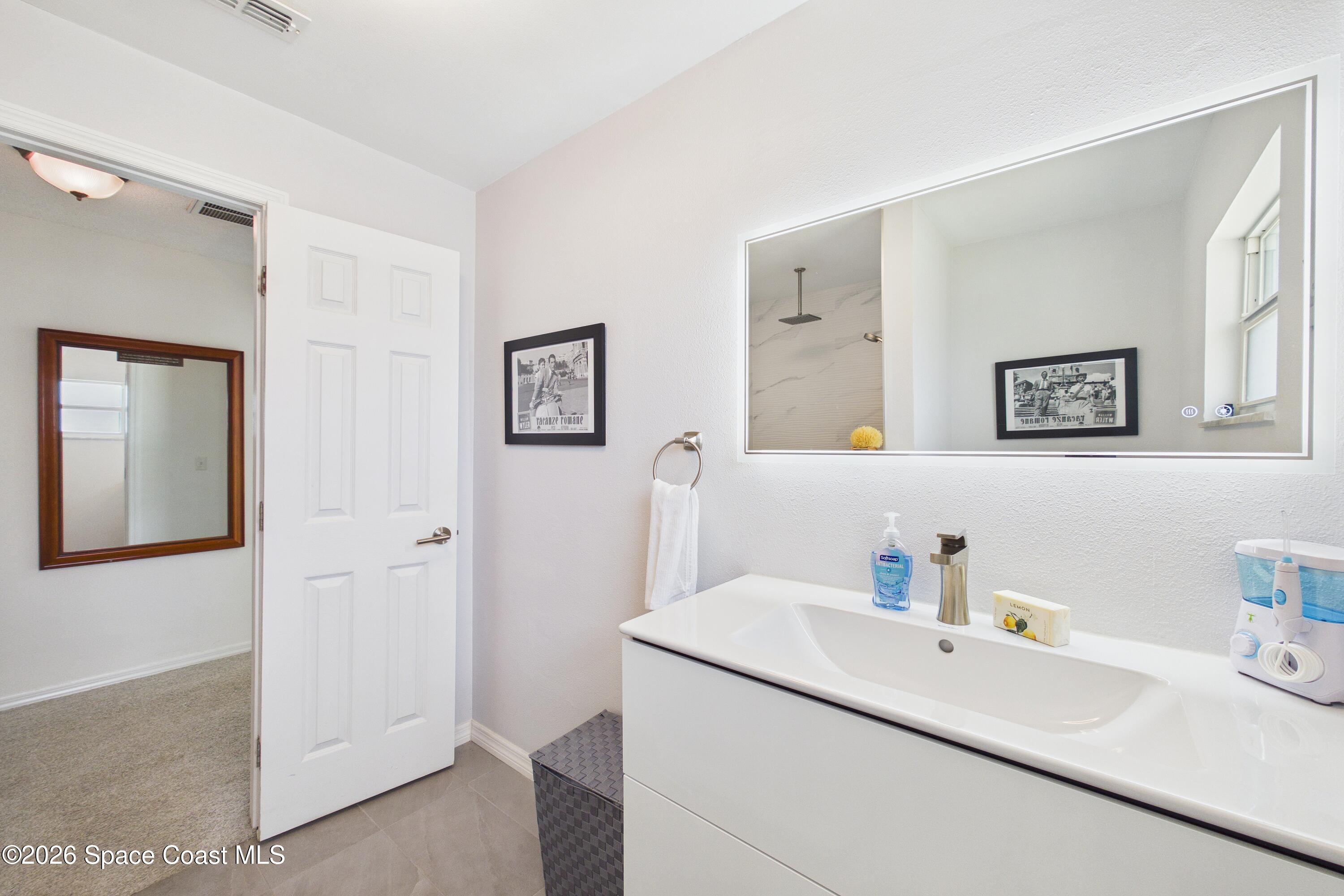 280 Coral Way West Indialantic, FL 32903 - Photo 35 of 72 a bathroom with a sink and a mirror