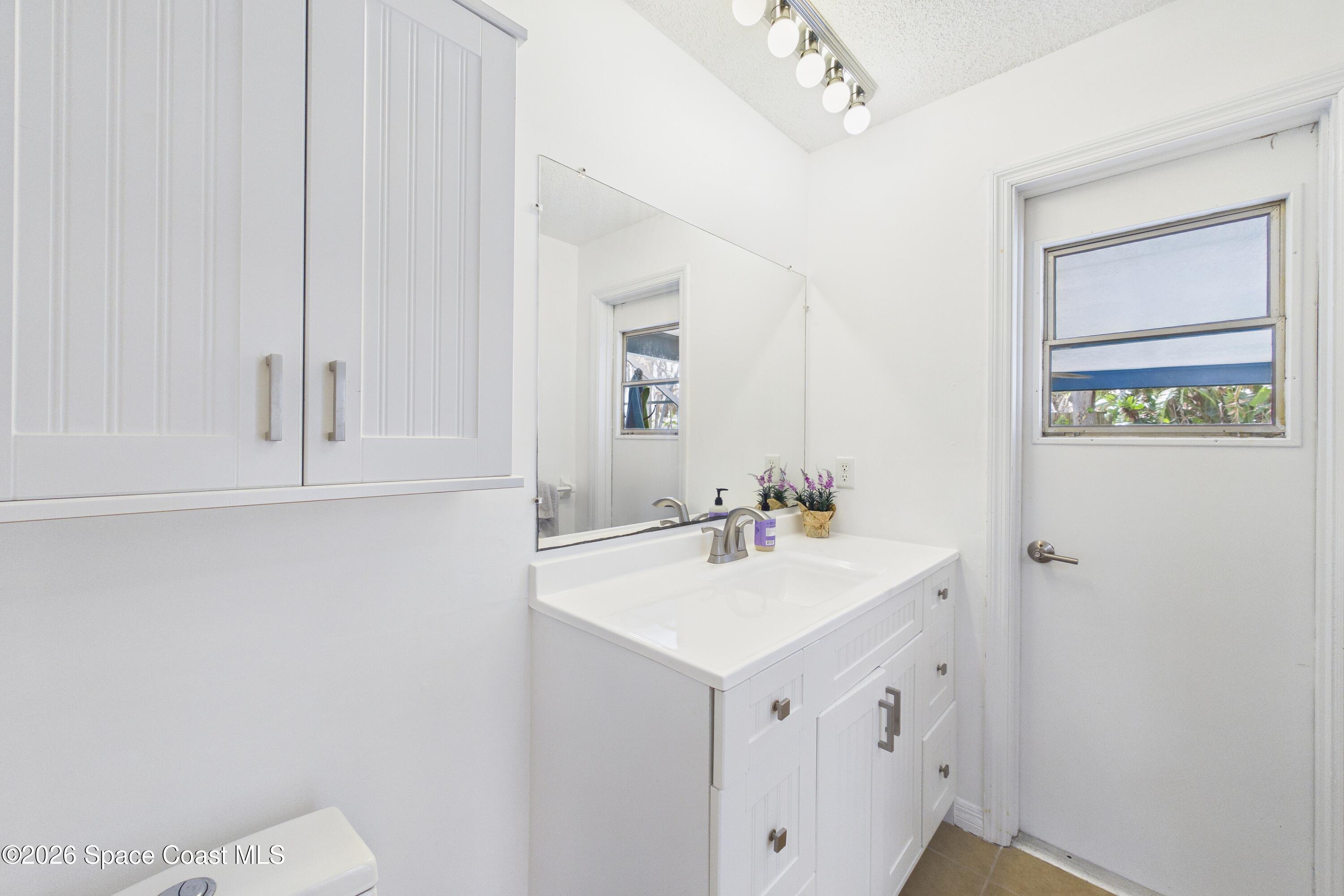 280 Coral Way West Indialantic, FL 32903 - Photo 38 of 72 a bathroom with a sink a vanity and a mirror