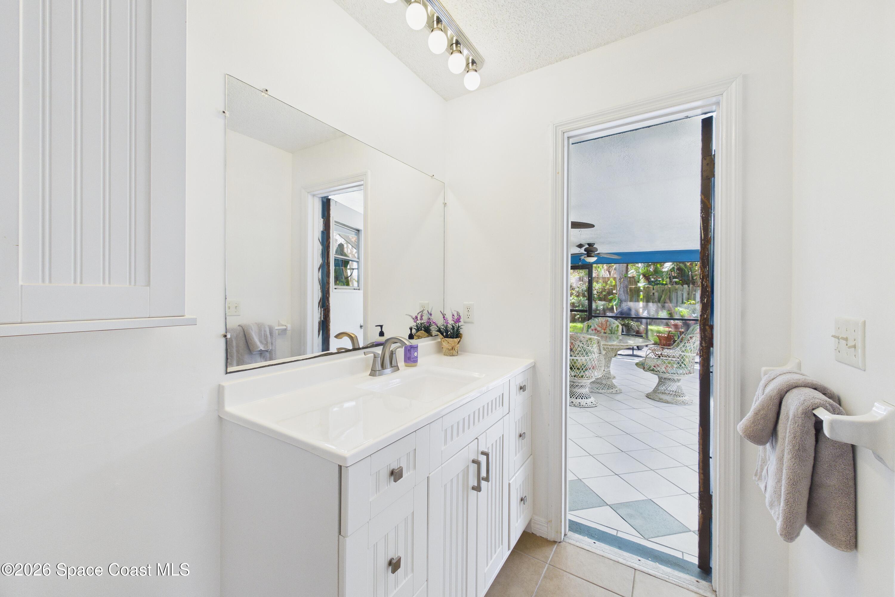 280 Coral Way West Indialantic, FL 32903 - Photo 39 of 72 a bathroom with a sink a toilet and mirror