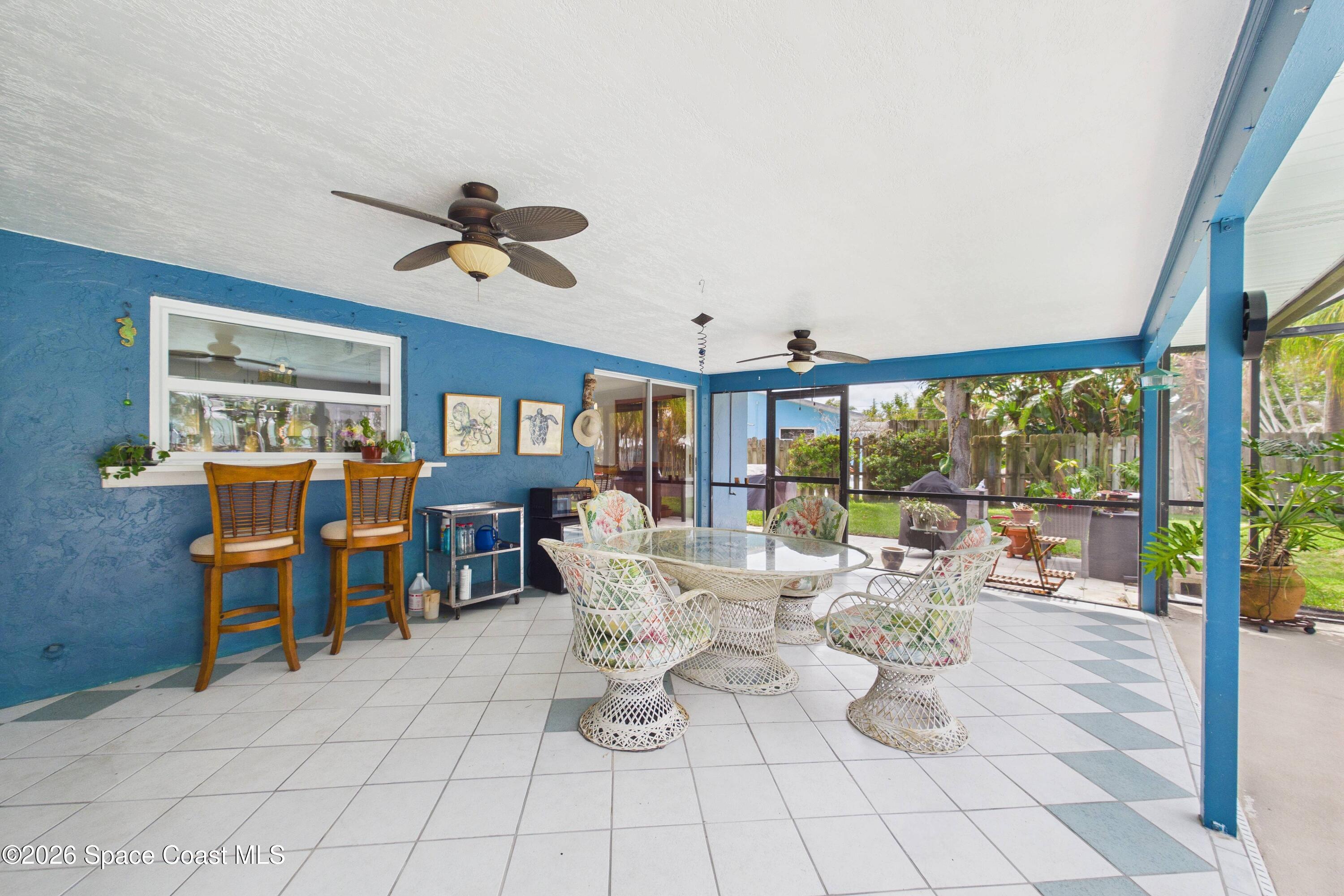 280 Coral Way West Indialantic, FL 32903 - Photo 45 of 72 a living room with patio furniture and a chandelier
