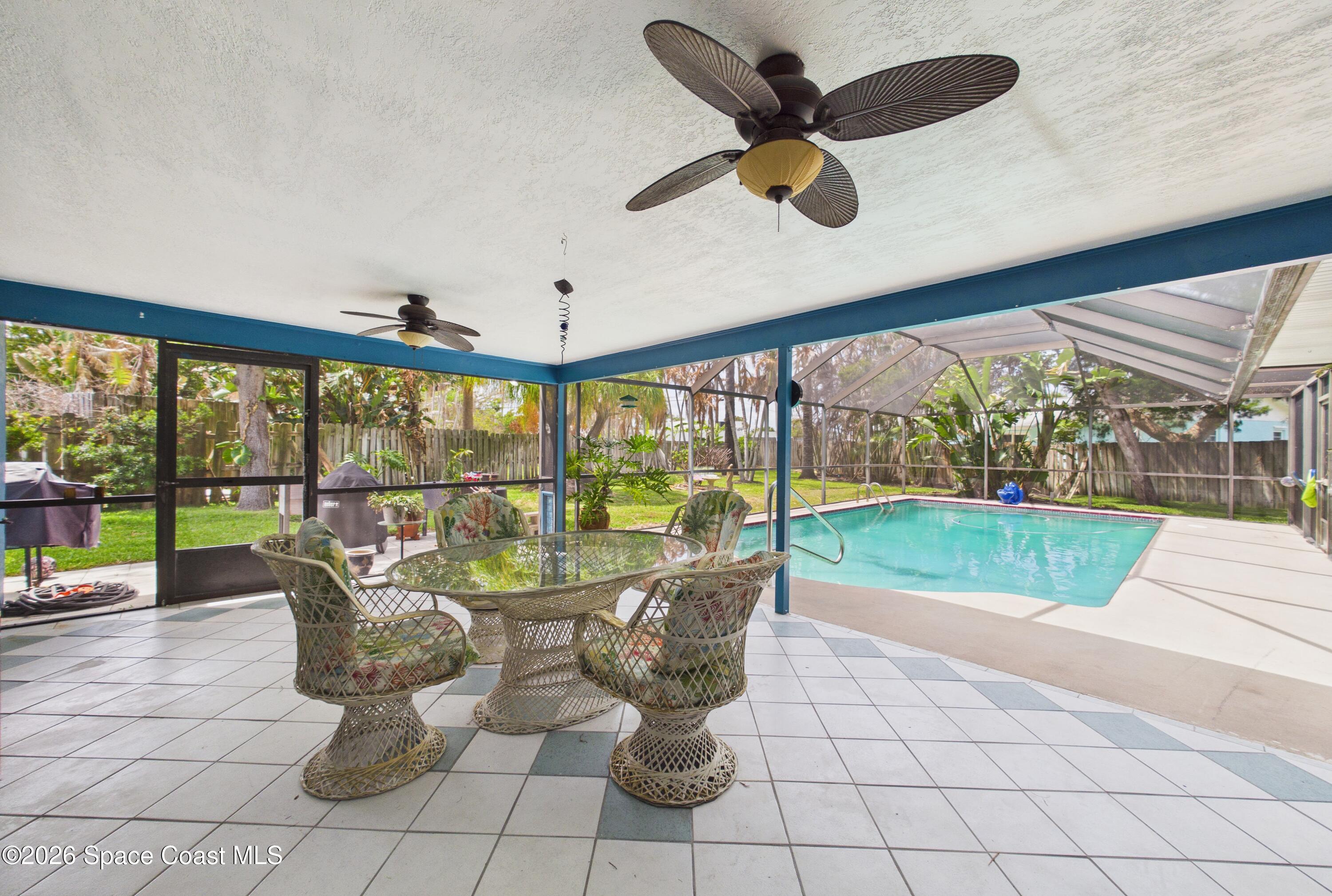 280 Coral Way West Indialantic, FL 32903 - Photo 47 of 72 a living room with patio furniture and a floor to ceiling window