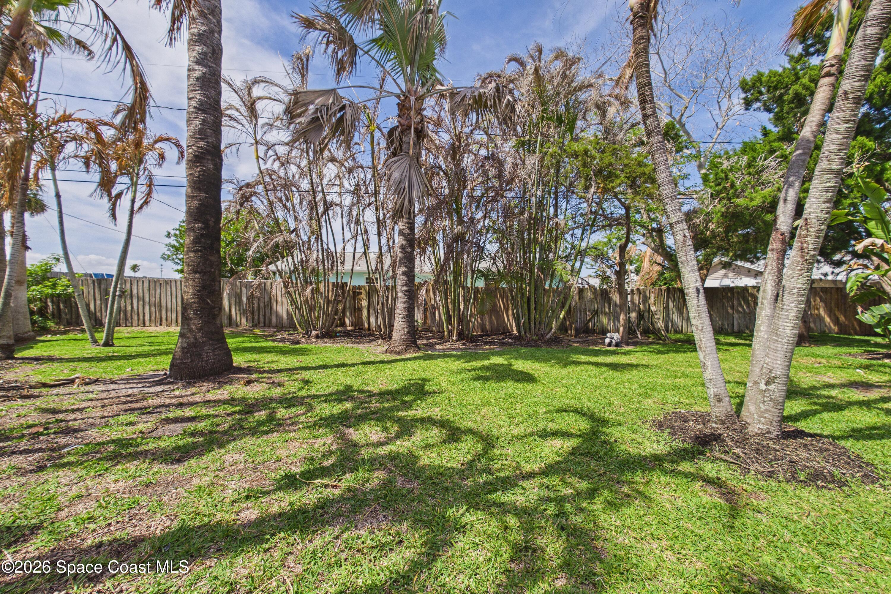280 Coral Way West Indialantic, FL 32903 - Photo 56 of 72 a backyard of a house with lots of green space