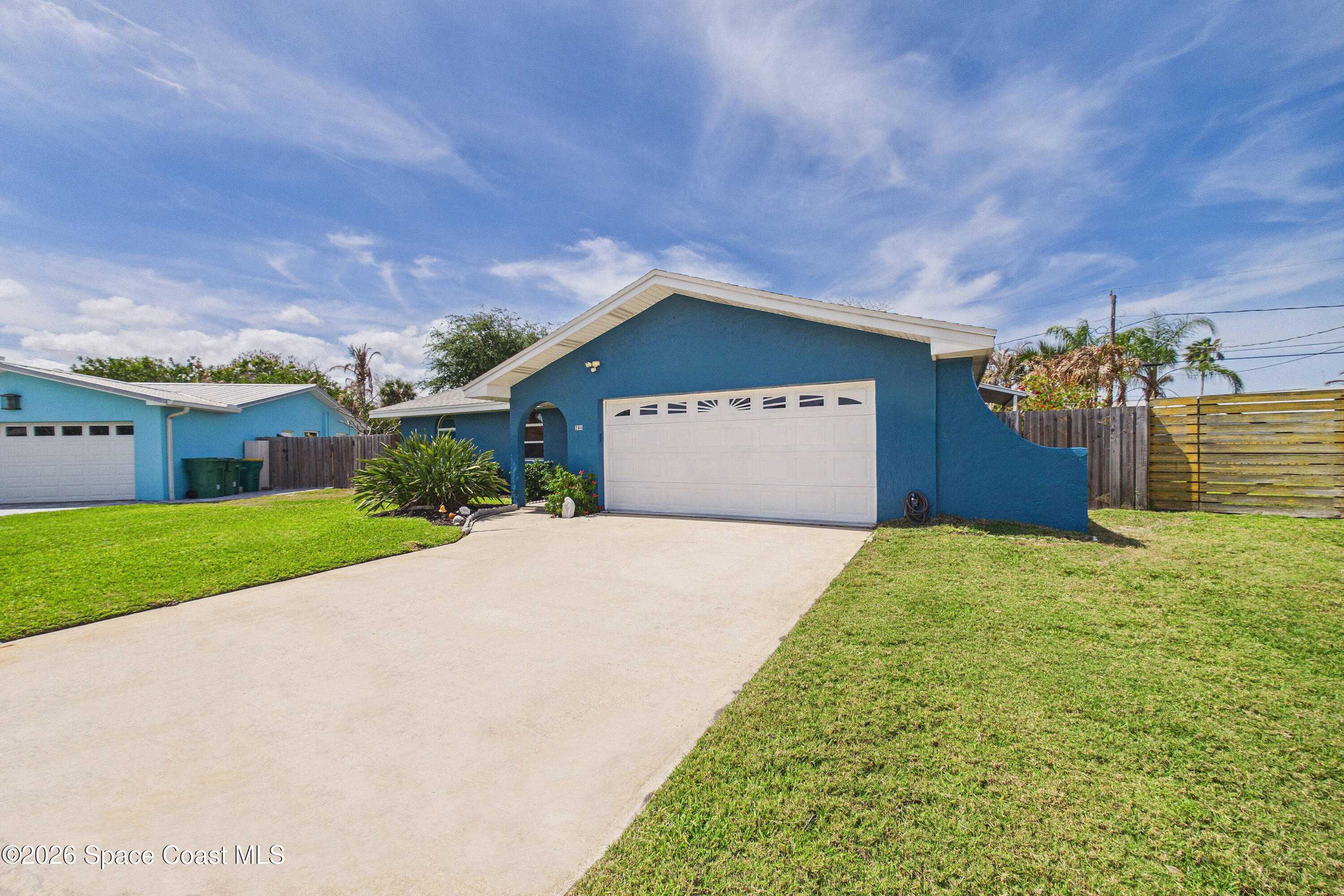 280 Coral Way West Indialantic, FL 32903 - Photo 61 of 72 a front view of a house with a yard and garage