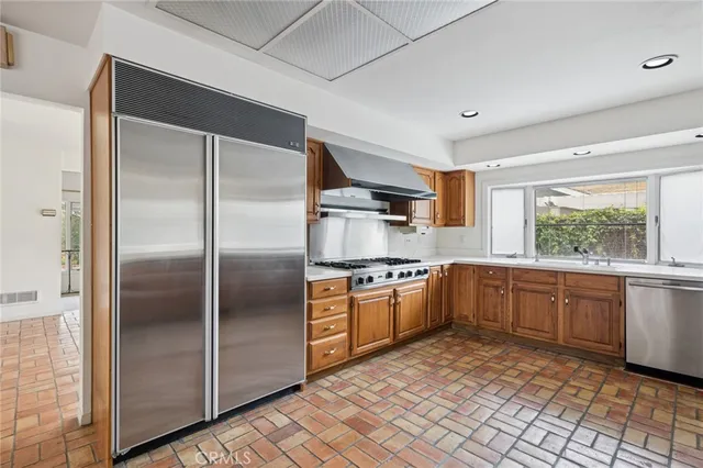 a kitchen with stainless steel appliances granite countertop a refrigerator and sink