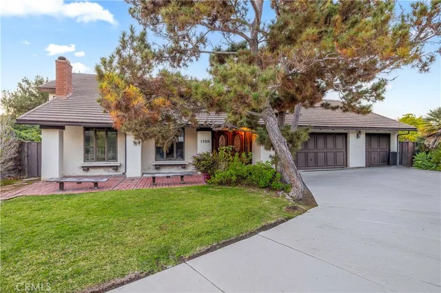 a front view of a house with a garden and porch