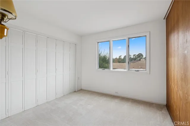 a spacious bathroom with a granite countertop double vanity sink a mirror and a shower