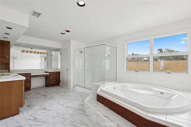 a spacious bathroom with a double vanity sink mirror and double