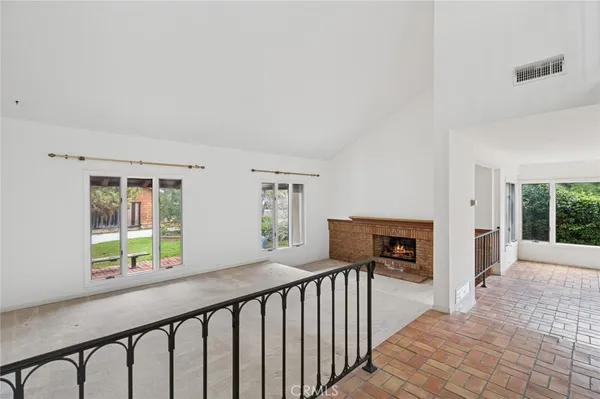 a view of a porch with wooden floor and iron fence
