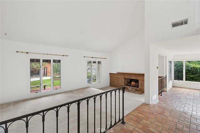 a view of a porch with wooden floor and iron fence
