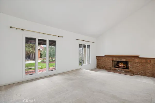 an empty room with furniture and a window