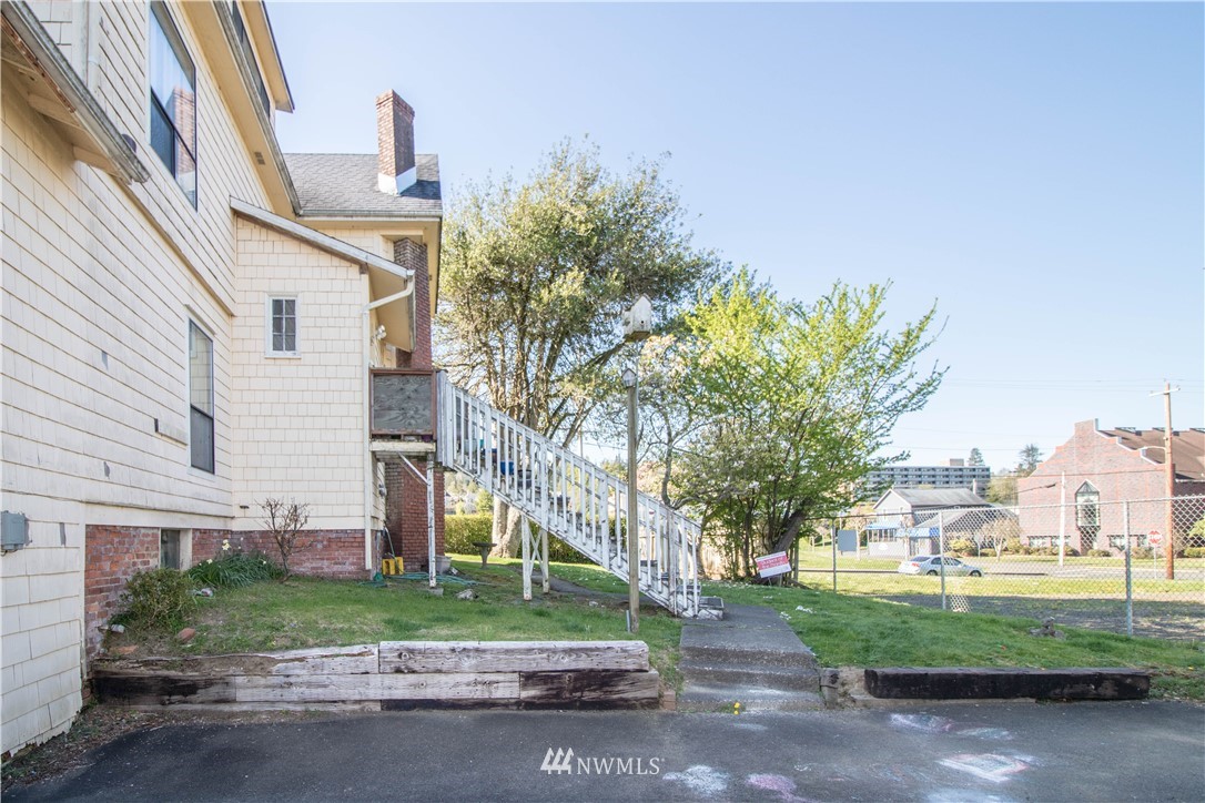 211 East 3rd Street Aberdeen, WA 98520 - Photo 8 of 27 a front view of a house with a yard and garage