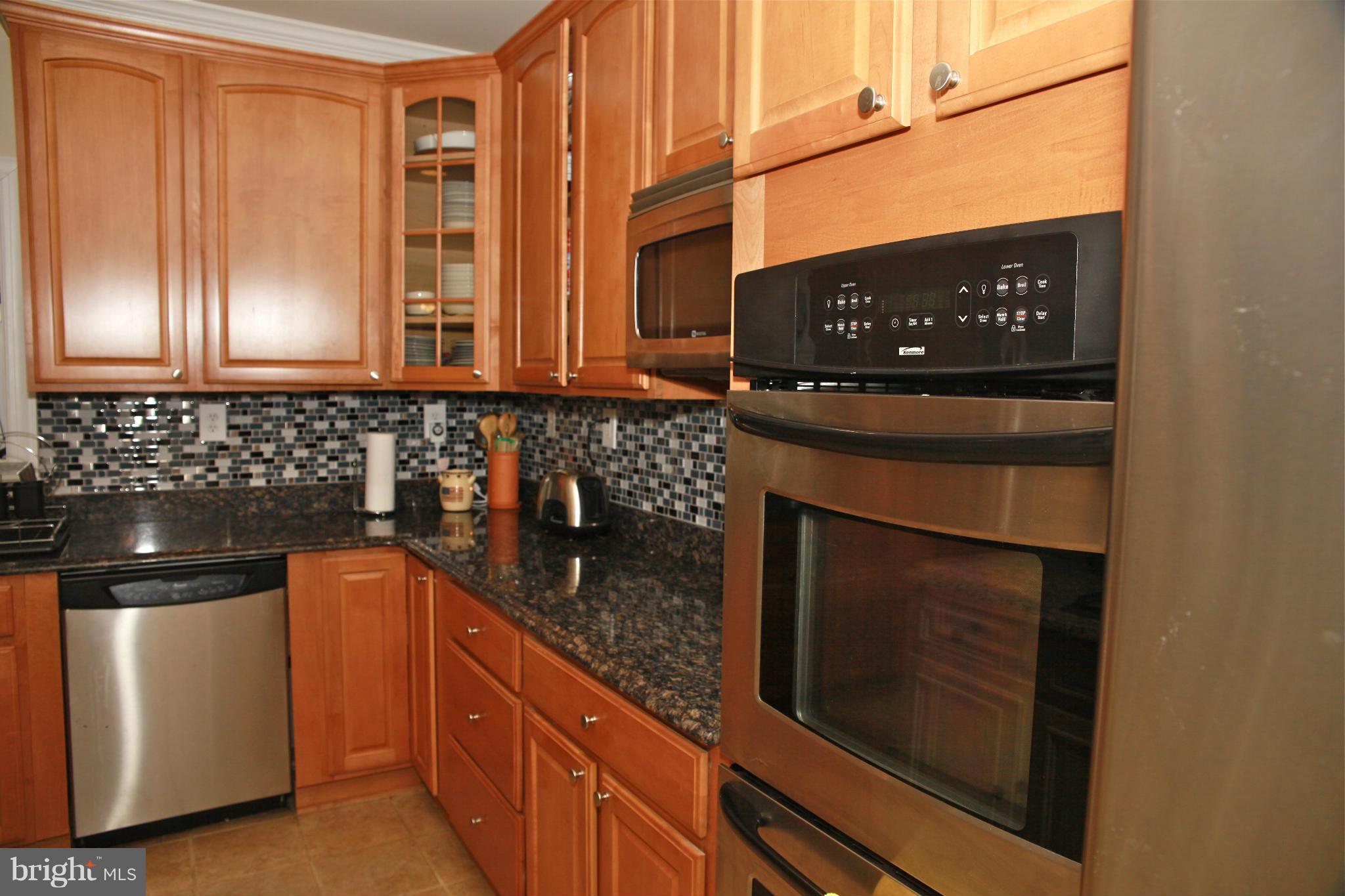 5313 Franconia Road Alexandria, VA 22310 - Photo 17 of 29 a kitchen with stainless steel appliances granite countertop a stove and a microwave