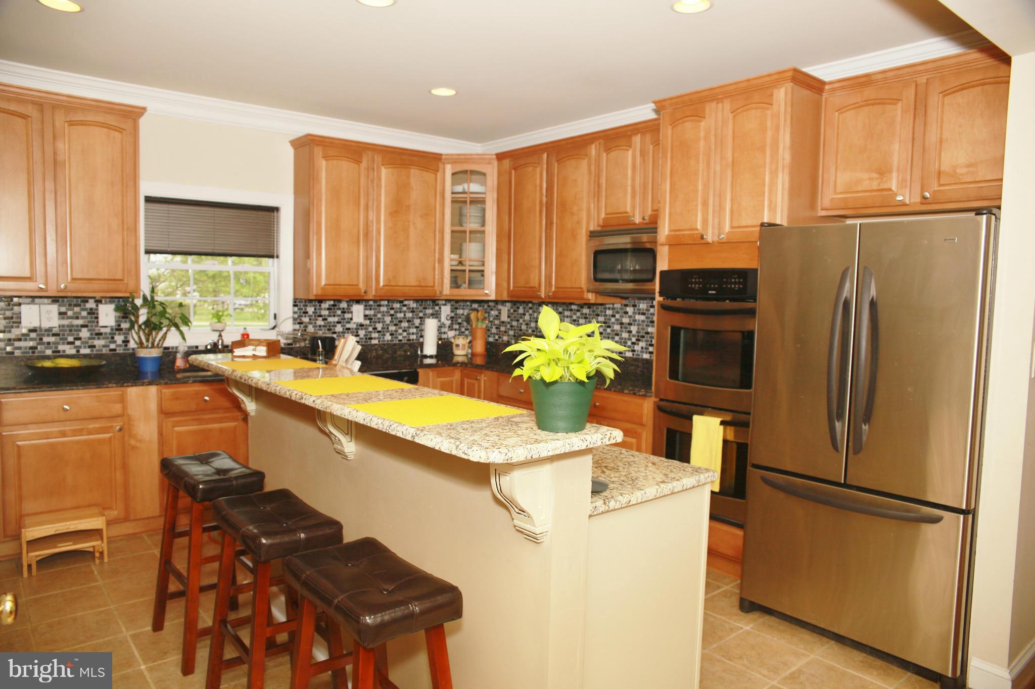 5313 Franconia Road Alexandria, VA 22310 - Photo 5 of 29 a kitchen with refrigerator and chairs