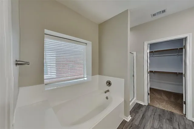 a bathroom with a bathtub and a shower