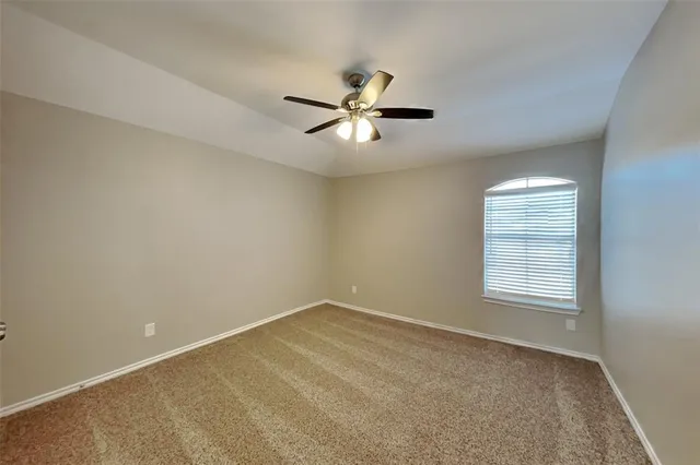 a view of a room with windows and ceiling fan