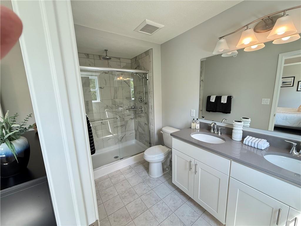 178 Lockheed Drive Coraopolis, PA 15108 - Photo 16 of 22 a bathroom with a granite countertop sink toilet and shower
