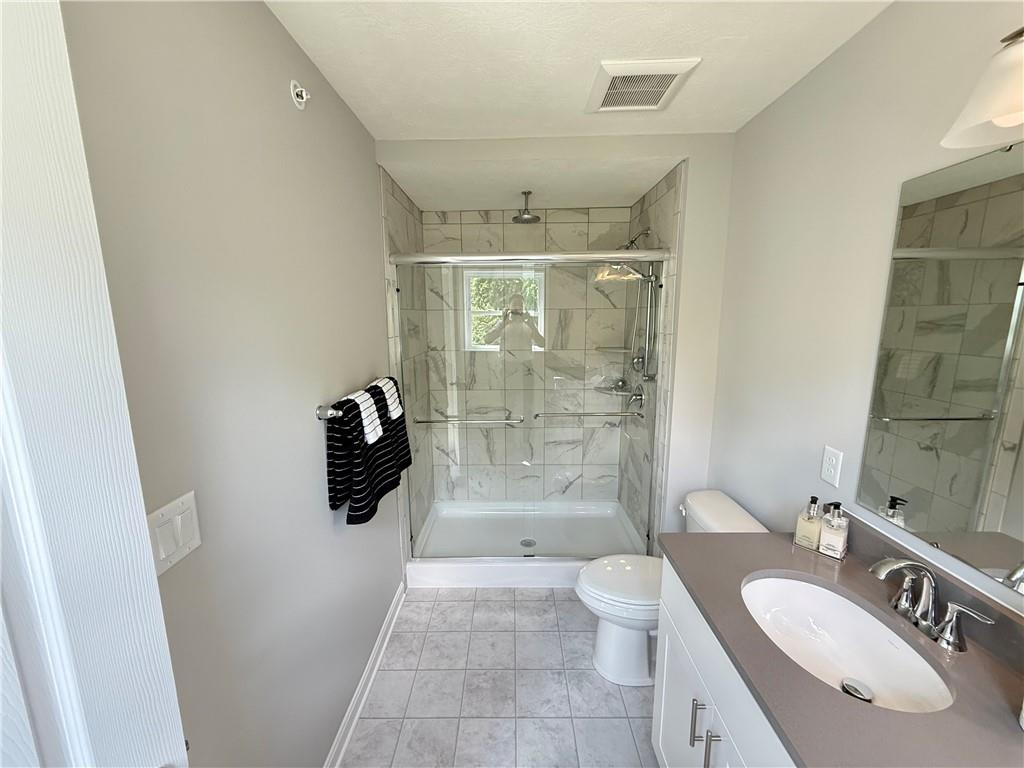 178 Lockheed Drive Coraopolis, PA 15108 - Photo 17 of 22 a bathroom with a granite countertop sink toilet and shower