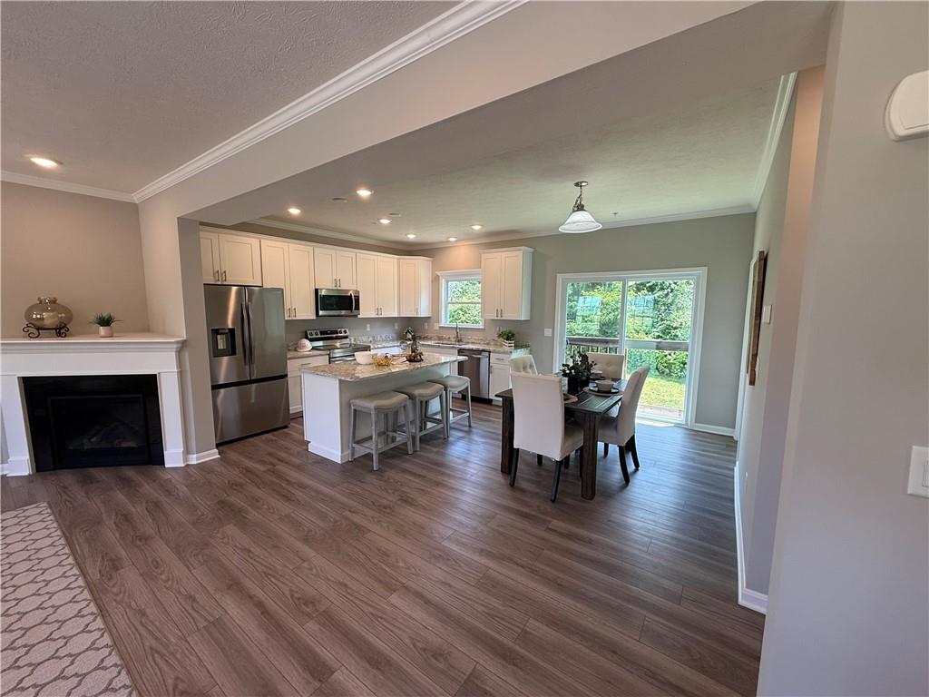 178 Lockheed Drive Coraopolis, PA 15108 - Photo 4 of 22 a kitchen with a table chairs refrigerator and cabinets