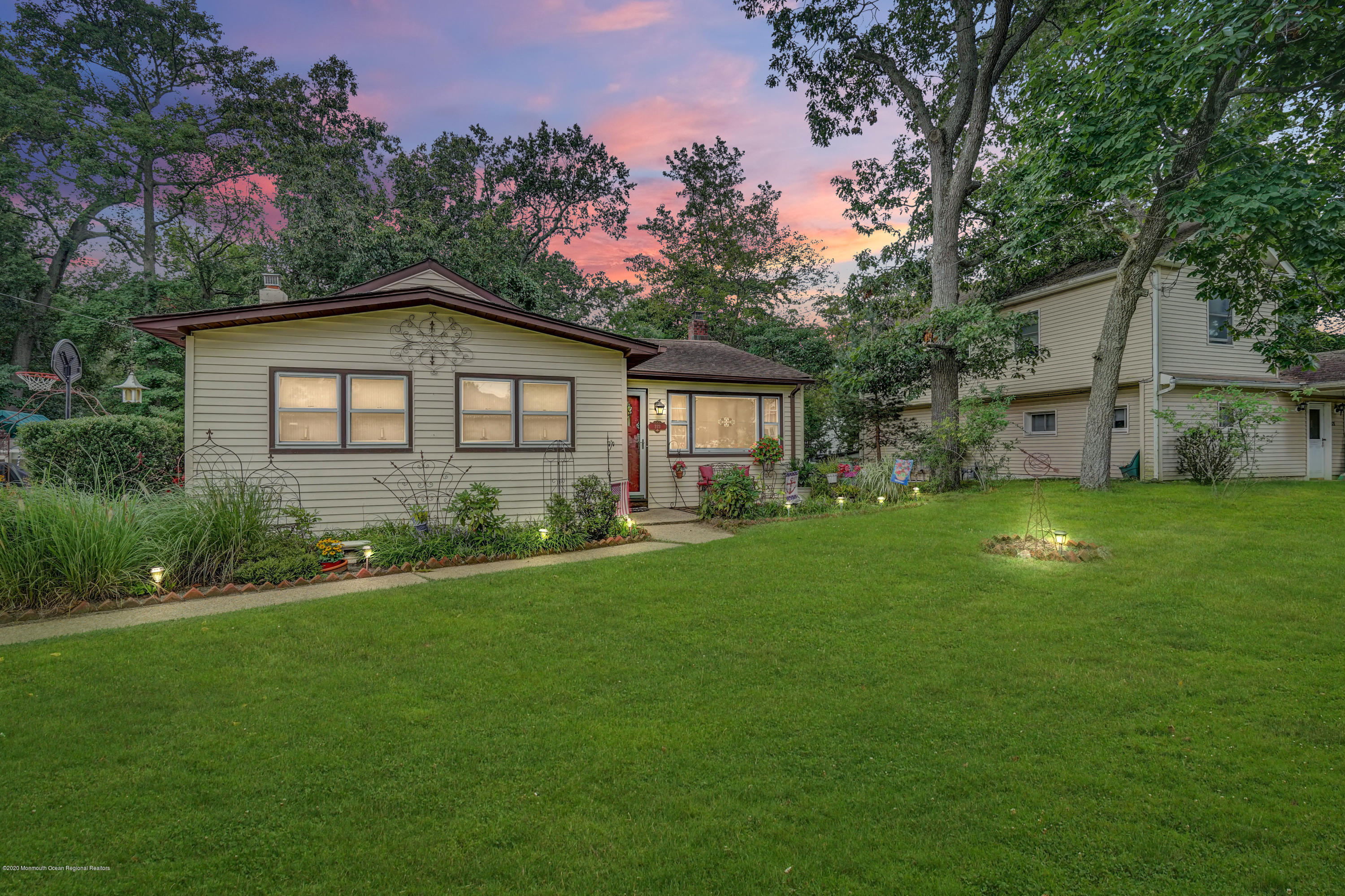 a front view of house with yard and green space