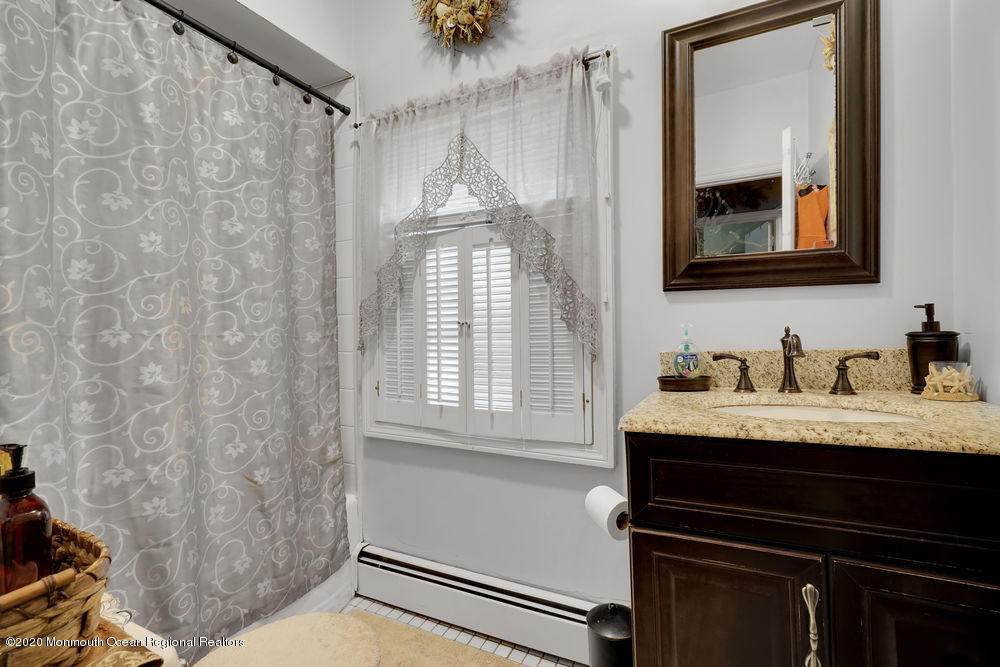 223 Delaware Avenue Oakhurst, NJ 07755 - Photo 12 of 30 a bathroom with a granite countertop sink vanity mirror and shower