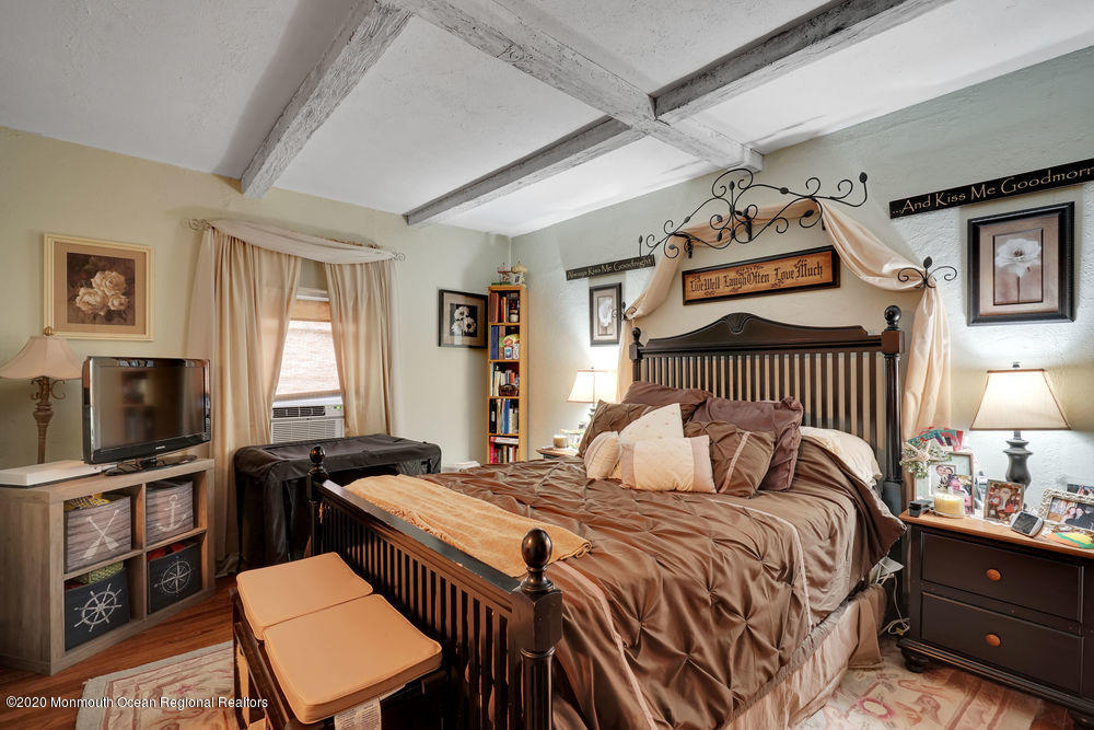 223 Delaware Avenue Oakhurst, NJ 07755 - Photo 14 of 30 a bedroom with a bed and a tv on the dresser