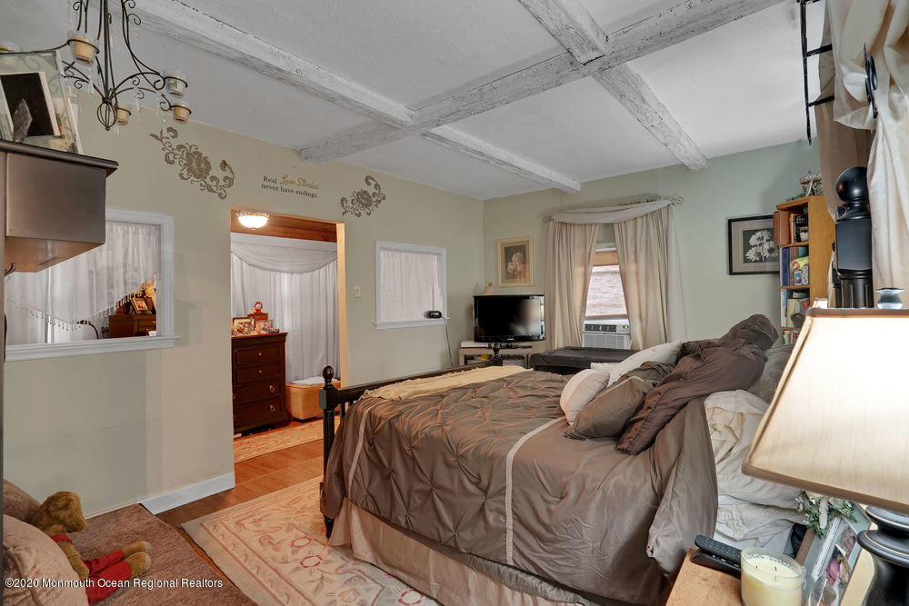 223 Delaware Avenue Oakhurst, NJ 07755 - Photo 15 of 30 a bed room with a bed and a television